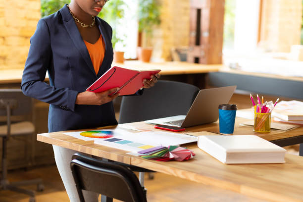 istock Busy interior designer standing near her working table 1168517590