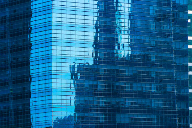 Office buildings windows. Blue glass architecture facade design with reflection of sky in urban city, Downtown Singapore City in financial district.