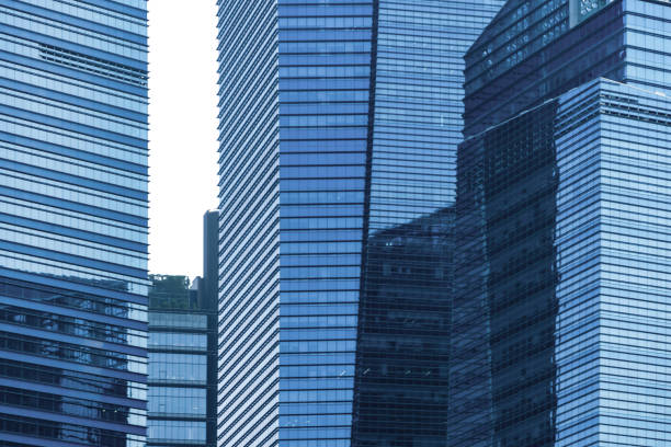istock Office buildings windows. Blue glass architecture facade design with reflection of sky in urban city, Downtown Singapore City in financial district. 1168519436