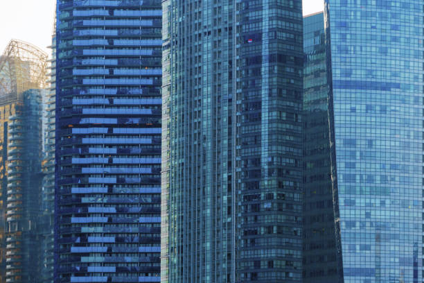 istock Office buildings windows. Blue glass architecture facade design with reflection of sky in urban city, Downtown Singapore City in financial district. 1168519450