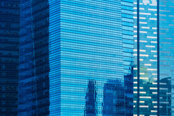 istock Office buildings windows. Blue glass architecture facade design with reflection of sky in urban city, Downtown Singapore City in financial district. 1168519472