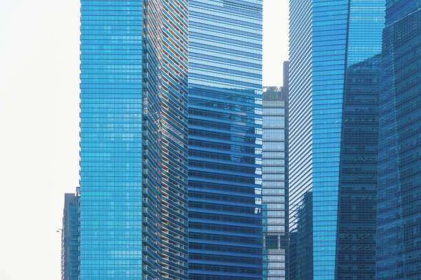 istock Office buildings windows. Blue glass architecture facade design with reflection of sky in urban city, Downtown Singapore City in financial district. 1168519485