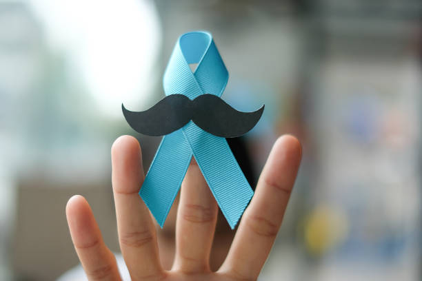istock Prostate Cancer Awareness, wonan hand holding light Blue Ribbon with mustache for supporting people living and illness. Men Healthcare and World cancer day concept 1168524057