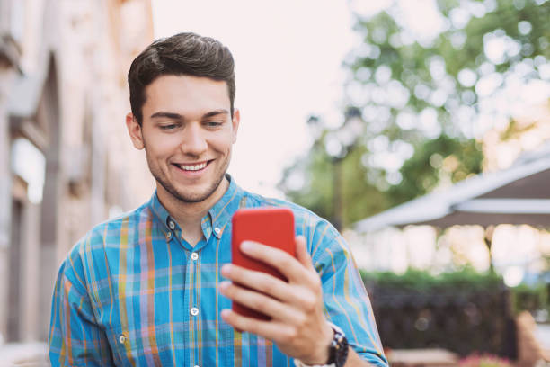 istock Handsome young man using smart phone in a city 1168524204