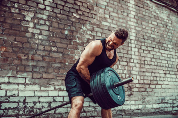 istock Athletic man working out with a barbell. Strength and motivation. Exercise for the muscles of the back 1168526609