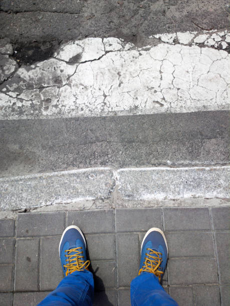 istock Feet near a pedestrian crossing. 1168530651