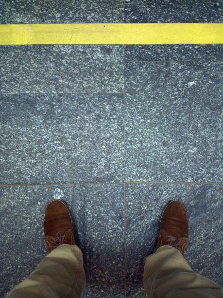 istock Feet near yellow line. 1168530698