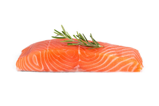 raw salmon piece with rosemary isolated on white background raw salmon piece with rosemary isolated on white background trout photos stock pictures, royalty-free photos & images