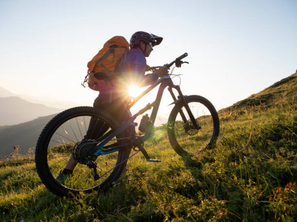 istock Mountain biker carrying his bicycle to the top. 1168532078
