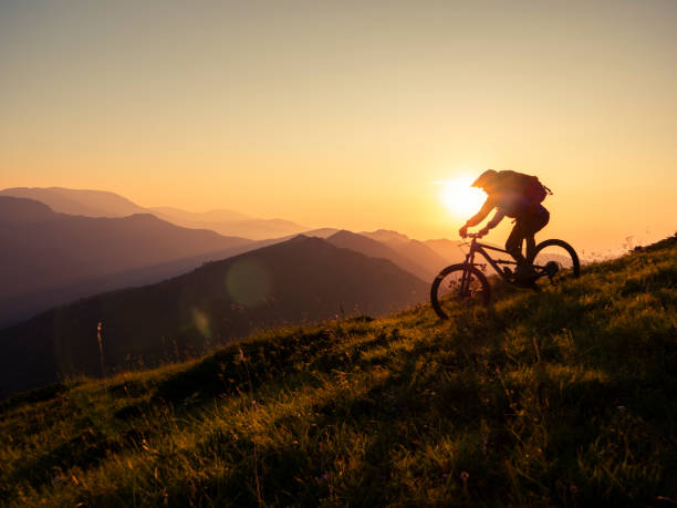 istock Mountain biker riding downhill in mountain. 1168532135