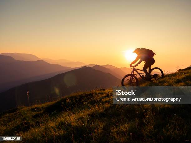 Mountain Biker Riding Downhill In Mountain Stock Photo - Download Image Now - Cycling, Mountain Bike, Mountain Biking