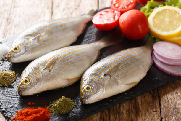istock Raw Sarpa salpa with ingredients close-up on a slate board. horizontal 1168533774