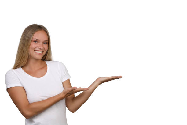 istock Pretty woman smiles into the camera as she points her hands in one direction 1168534883