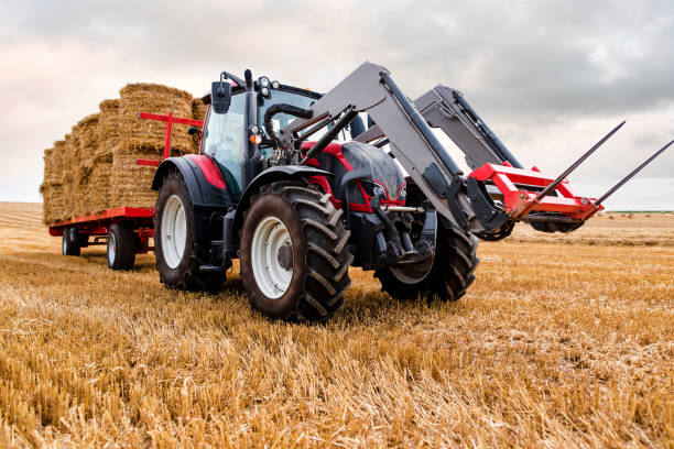 istock tractor and its trailer for harvesting straw bales 1168540478