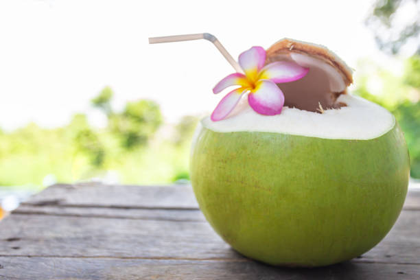 istock Coconut drink on wooden floor blurred background 1168541681