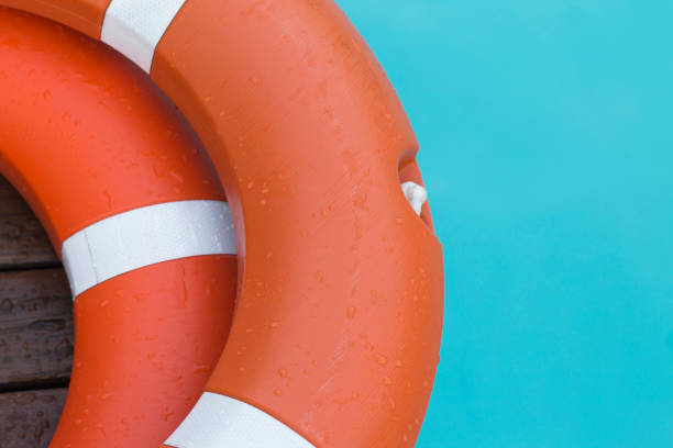 istock Orange lifebuoy in turquoise water 1168542513