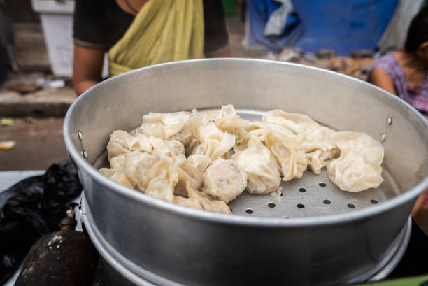 Momos Steamed Chicken Momos displayed for Sale at Teretti bazaar, Kolkata. Momo is a type of South Asian dumpling. chinese dumpling stock pictures, royalty-free photos & images