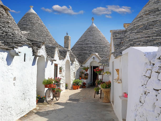 Traditional Apulian Trulli houses. Apulia, Italy Traditional Apulian Trulli houses - dry stone huts with a conical roof. Italy alberobello stock pictures, royalty-free photos & images