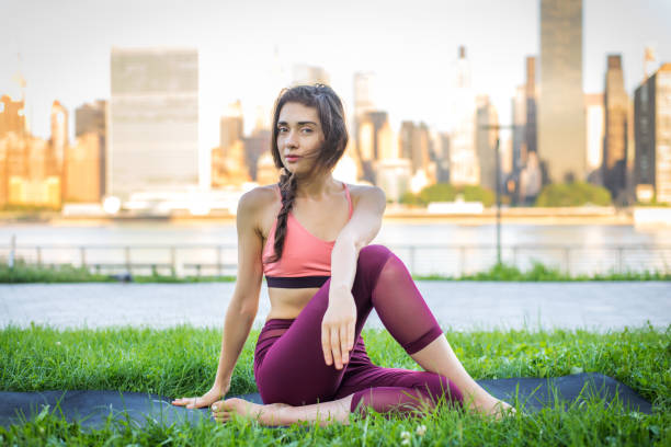 istock Woman doing yoga in a park 1168547737