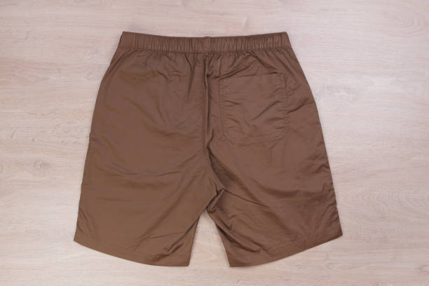 istock Back brown casual short pants on wooden background 1168554277