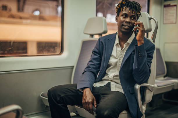 istock Black man talking on phone in subway train 1168555347
