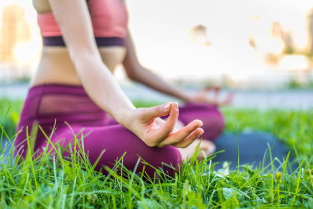 istock Woman doing yoga in a park 1168557068