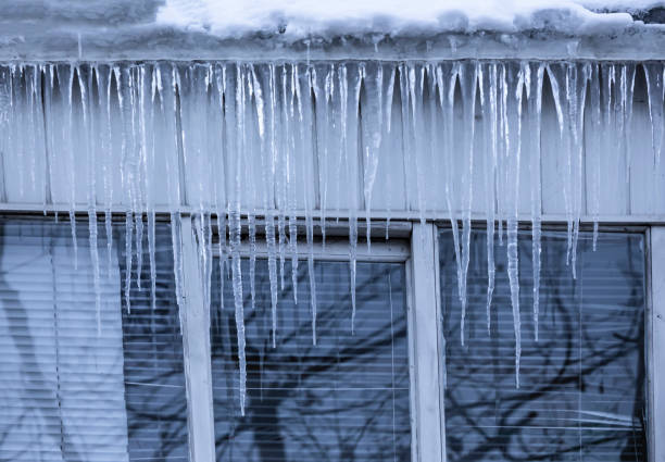 istock Transparent icicles on the roof. 1168558712