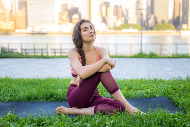istock Woman doing yoga in a park 1168559690