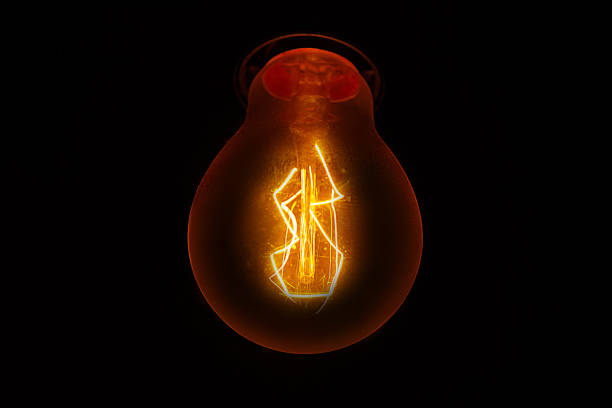 istock Light bulb with beautiful filament on a dark background 1168562400