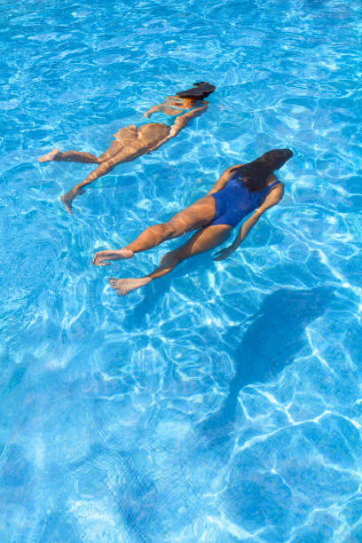 istock Two women diving in a swimming pool 1168563303