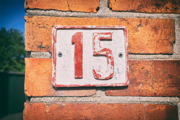 istock Street number 15 on a sign 1168564644