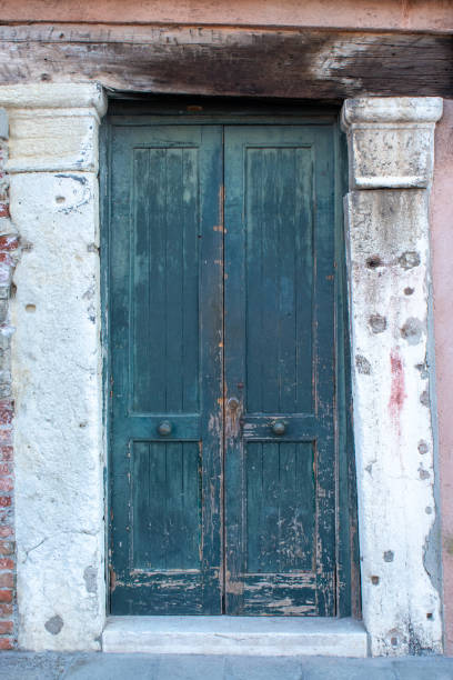 istock Old wooden door on a stone built building 1168567899