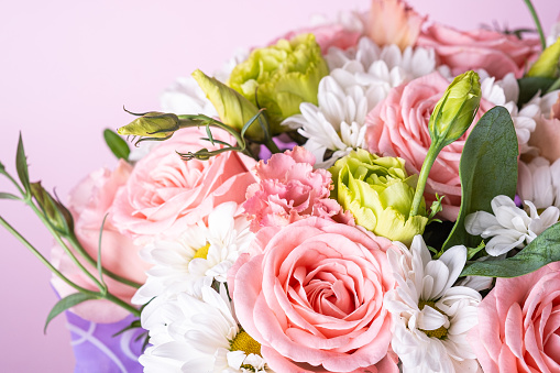 Bouquet of pink roses and white chrysanthemums with green plants