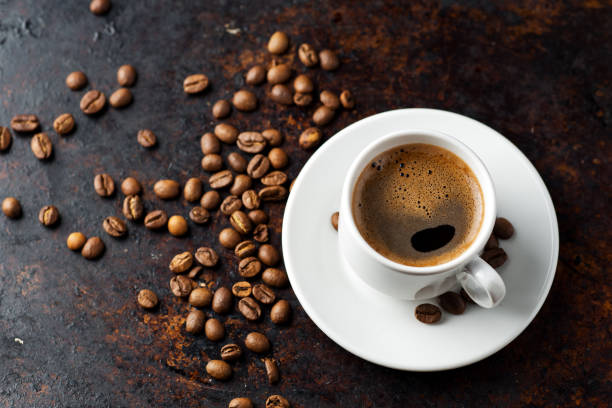 istock White espresso coffee Cup and coffee beans on rusty dark background 1168570731