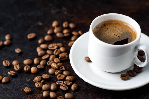 istock White espresso coffee Cup and coffee beans on rusty dark background 1168570738