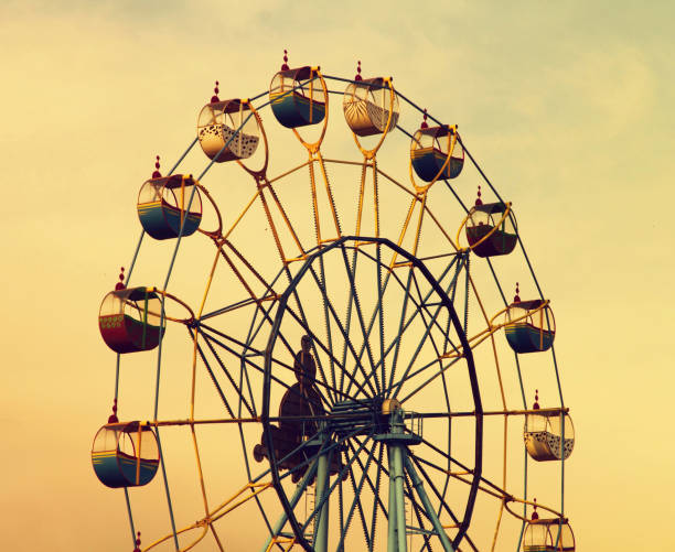 istock Ferris wheel on evening cloudy sky background. 1168570778