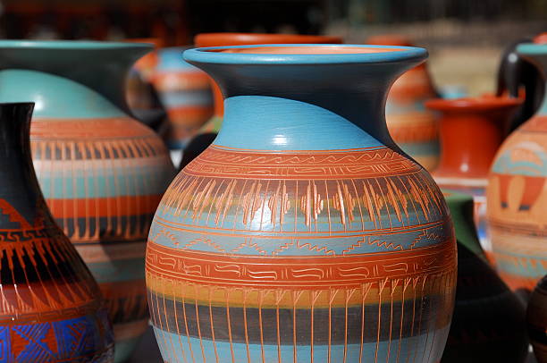 Blue and brown patterned Navaho pottery Native American pottery lined up for sale at an outdoor market in Sante Fe, New Mexico. santa fe new mexico stock pictures, royalty-free photos & images