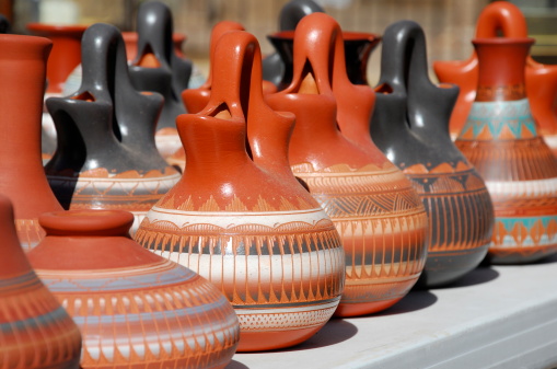 Native American pottery lined up for sale at an outdoor market in Sante Fe, New Mexico.