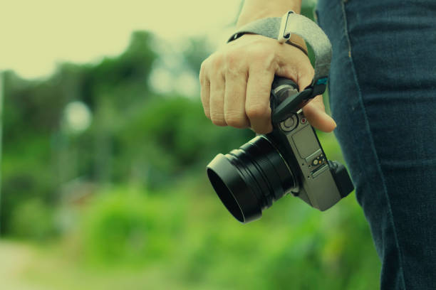 istock Woman hand holding digital camera isolated on white blackground with copy space. 1168579091