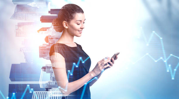 istock Smiling woman using smartphone in city, graphs 1168582552