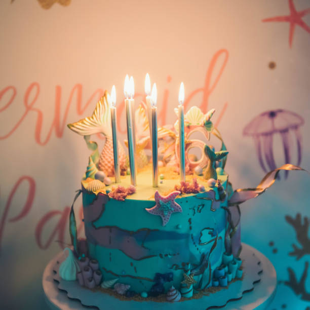 istock Lighting candles on birthday cake. 1168583078