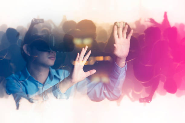 young asian officer man playing and hand touch effect of magic from Virtual reality with black hololens glasses