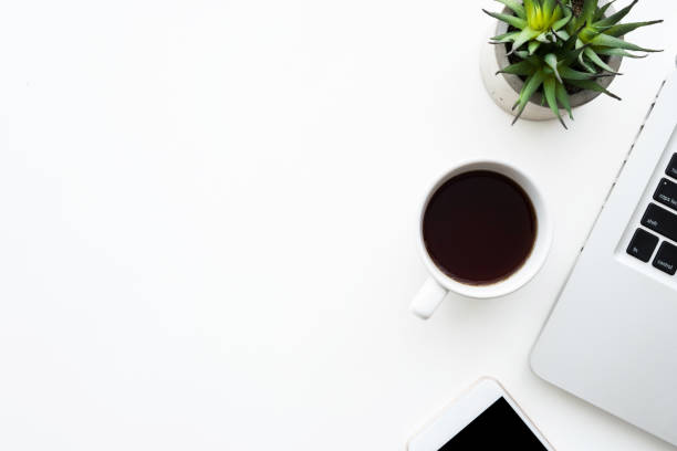 istock White office desk table with laptop computer, cup of coffee and smartphone. Top view with copy space, flat lay. 1168587604