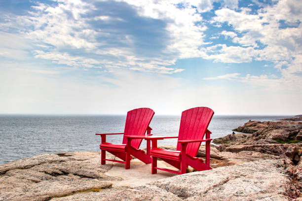 Adirondack red chairs near Tadoussac, Quebec, Canada for whales watching in the St-Lawrence river