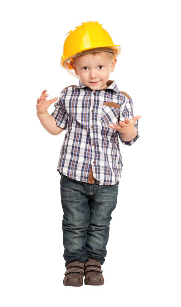 istock Portrait Of Boy Wearing Hardhat While Standing Against White Background 1168593970