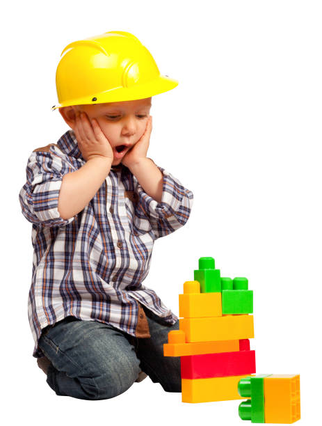 istock Boy Playing With Toy Blocks While Sitting Against White Background 1168595644