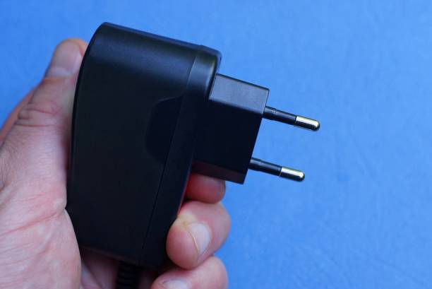 istock hand holds a charger on a blue background 1168597217