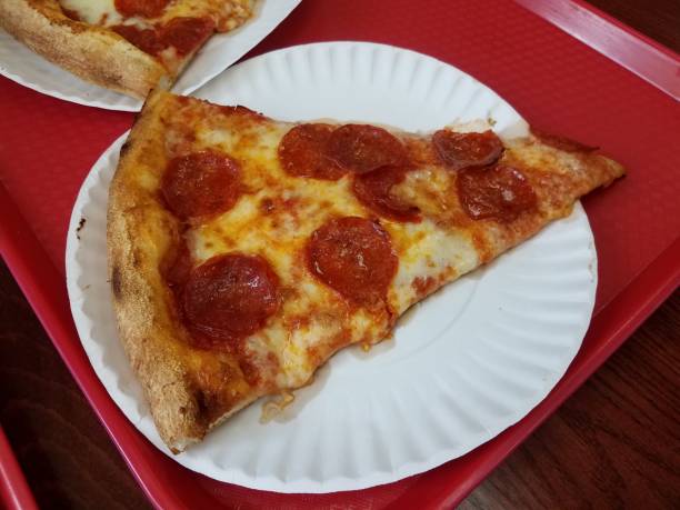istock pepperoni pizza slice on paper plate and red tray 1168597410