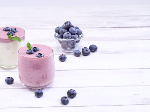 istock Fresh blueberry yogurt and mint leaves placed on a white wooden table. Fruit vitamins for health. 1168601003