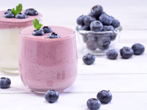 istock Fresh blueberry yogurt and mint leaves placed on a white wooden table. Fruit vitamins for health. 1168601036